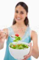 Portrait of a woman showing a salad