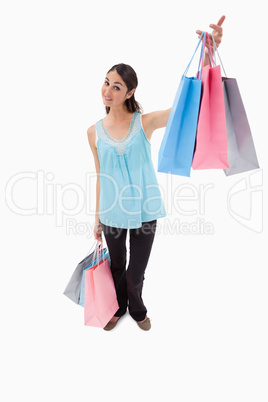 Portrait of a happy woman showing shopping bags