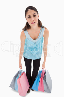 Portrait of a tired woman posing with shopping bags