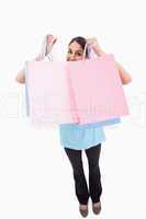 Portrait of a joyful woman showing shopping bags