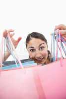 Portrait of a cheerful woman showing shopping bags