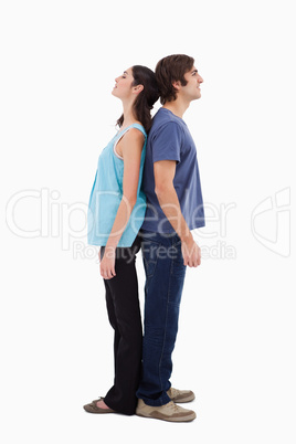 Portrait of a couple standing back to back