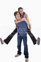 Portrait of man holding his girlfriend on his back