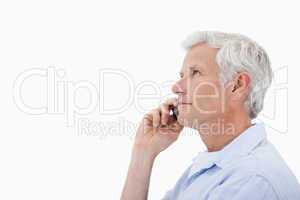 Side view of a man making a phone call