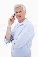 Portrait of a man making a phone call while looking at the camer