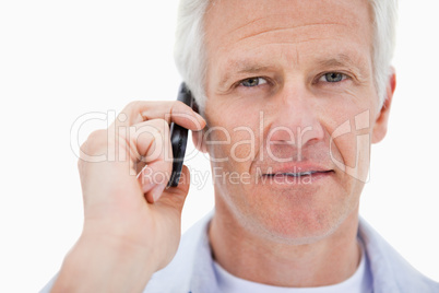 Mature man making a phone call