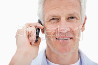 Smiling mature man making a phone call