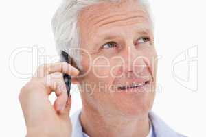 Mature man making a phone call while looking up