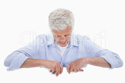 Portrait of a man standing behind blank panel