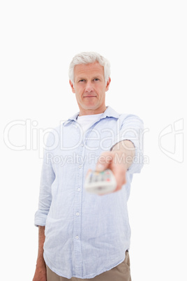 Portrait of a mature man switching of channel
