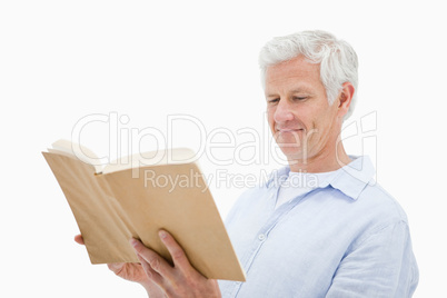 Happy mature man reading a book