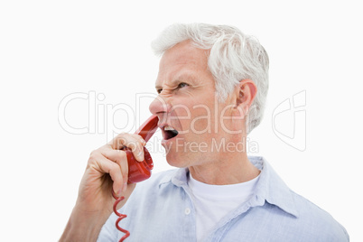 Angry man making a phone call