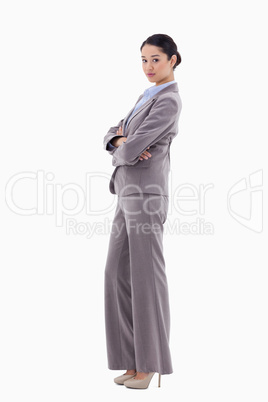 Portrait of a brunette businesswoman posing with the arms crosse