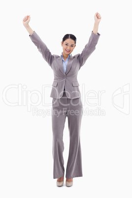 Portrait of a happy businesswoman posing with the arms up