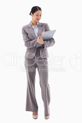 Portrait of a smiling businesswoman taking notes