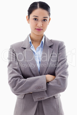 Portrait of a serious brunette businesswoman posing with the arm