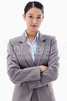 Portrait of a serious brunette businesswoman posing with the arm