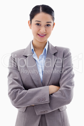 Portrait of a smiling brunette businesswoman posing with the arm