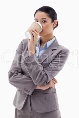 Portrait of a cute businesswoman drinking a takeaway coffee
