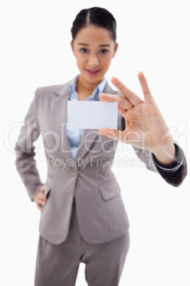 Portrait of a young businesswoman showing a blank business card