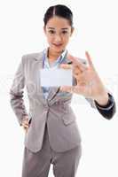 Portrait of a gorgeous businesswoman showing a blank business ca