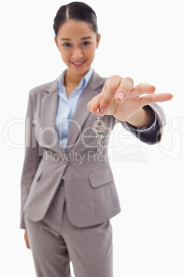 Portrait of a smiling businesswoman holding a key