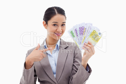 Smiling businesswoman holding bank notes