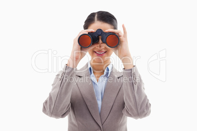 Businesswoman looking through binoculars