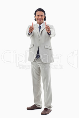 Portrait of a smiling office worker posing with the thumbs up