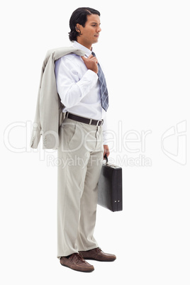 Portrait of a serious office worker holding his jacket over his