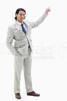 Portrait of a serious businessman pointing at a copy space