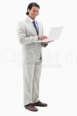 Portrait of a smiling businessman using a notebook