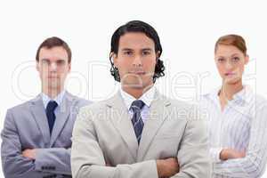 Three businesspeople with folded arms
