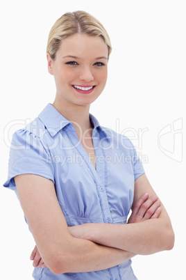 Smiling woman standing with arms folded