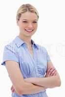 Smiling woman standing with arms folded