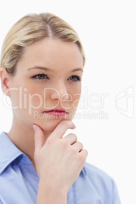 Thinking woman touching her chin