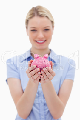 Piggy bank being held by young woman