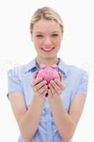 Piggy bank being held by young woman
