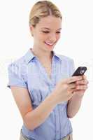 Smiling woman writing text message
