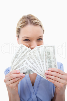 Woman hiding behind bank notes Woman hiding behind bank notes