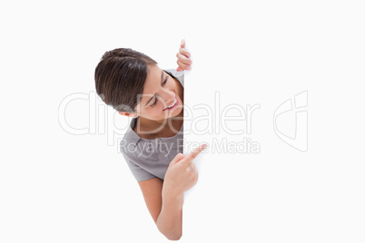 Woman pointing around the corner