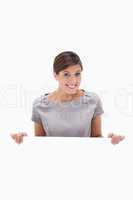 Smiling woman looking over blank wall