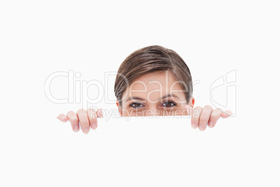Woman having a look over blank wall