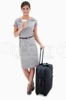Woman with coffee and wheely bag