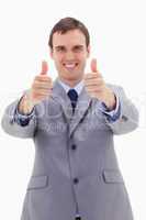 Thumbs up given by smiling businessman
