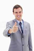 Smiling businessman giving thumb up