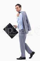 Side view of walking businessman with suitcase