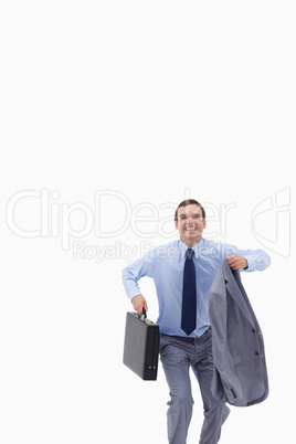 Happy businessman with suitcase about to jump