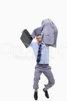 Happy businessman with suitcase jumping