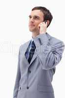 Businessman looking up while on the phone